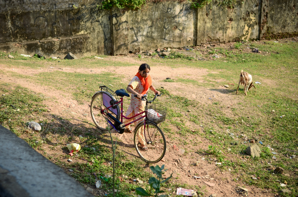 Girl with bicycle in Kochi, Kerala, India.