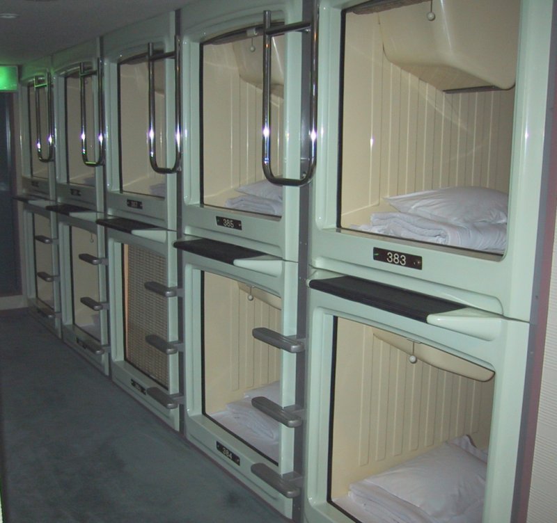 Here's what the interior of a common capsule hotel looks like in Japan. I stayed in a similar capsule hotel in the Asakusa district of Tokyo in 2003, which allowed smoking in the bedroom areas, which seemed like a horrible, stupid idea to me, because it is a horrible, stupid idea. Bathrooms were communal, so in the morning I scrubbed myself clean in a room full of stark naked Japanese businessmen (a realization of my greatest fantasy). Photo credit: Wikimedia Commons user "Chris 73".