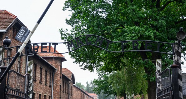 A sign reading "Arbeit Macht Frei" (labor will set you free) marks the entrance to Auschwitz I. A chilling, cruel trick of language - most prisoners of this camp would only find freedom in death.