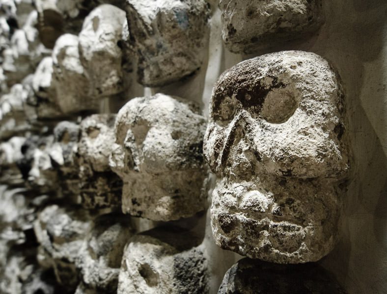A wall of stone skulls inside the Museo de Templo Mayor, in Mexico City's Centro Historico. GreatDistances.