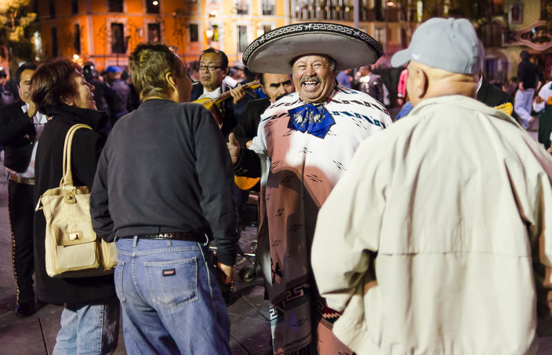 A mariachi band singer wearing a large sombrero smiles in Plaza Garibaldi, in Mexico City's Centro Historico.