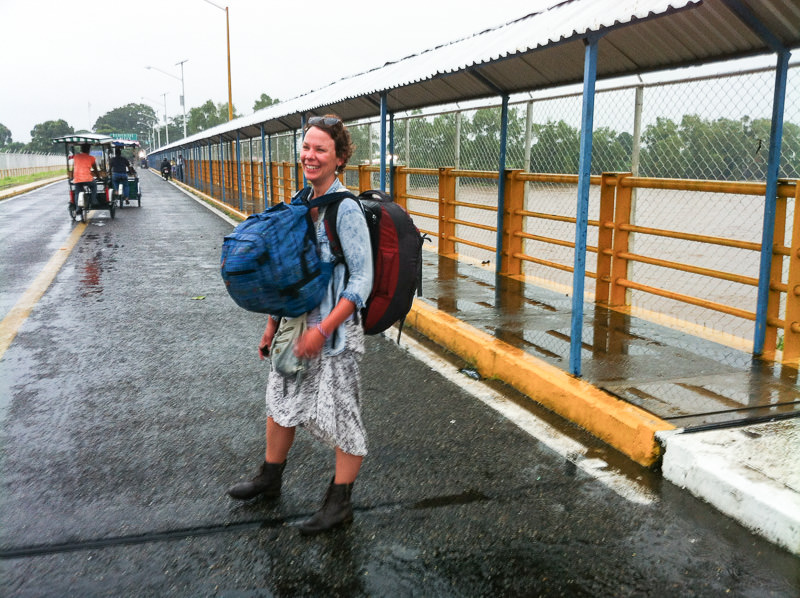 Backpacker woman straddling the border between Guatemala and Mexico. CA-4 Visa Renewal - GreatDistances