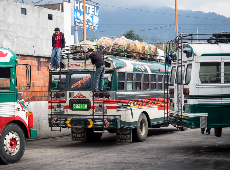 Volcan Tajumulco trek, Guatemala - boys hang on to the back of a camioneta in San Marcos - GreatDistances / Matt Wicks