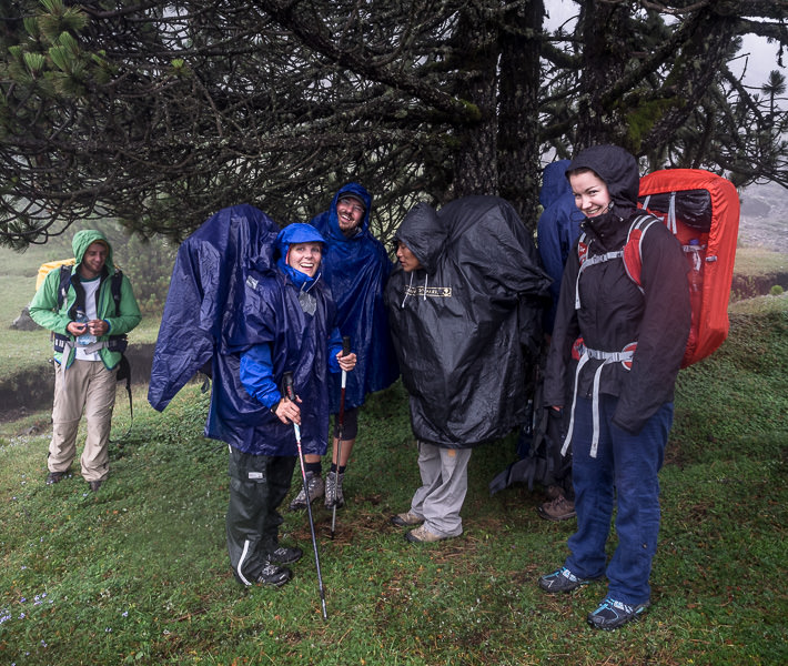 Volcan Tajumulco trek, Guatemala - smiling backpackers in rain gear - GreatDistances / Matt Wicks
