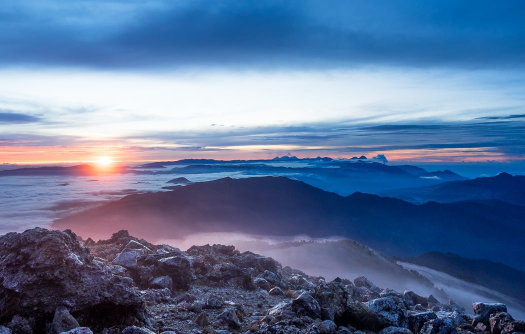 Sunrise reveals a horizon full of volcanoes. Summit of Volcán Tajumulco, Guatemala - GreatDistances / Matt Wicks