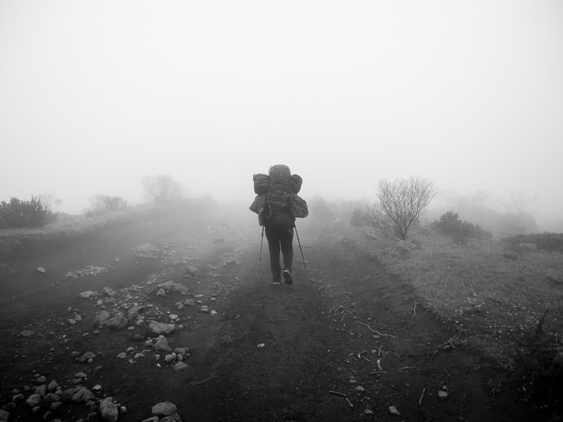 backpacker hiking down Volcan Tajumulco in fog