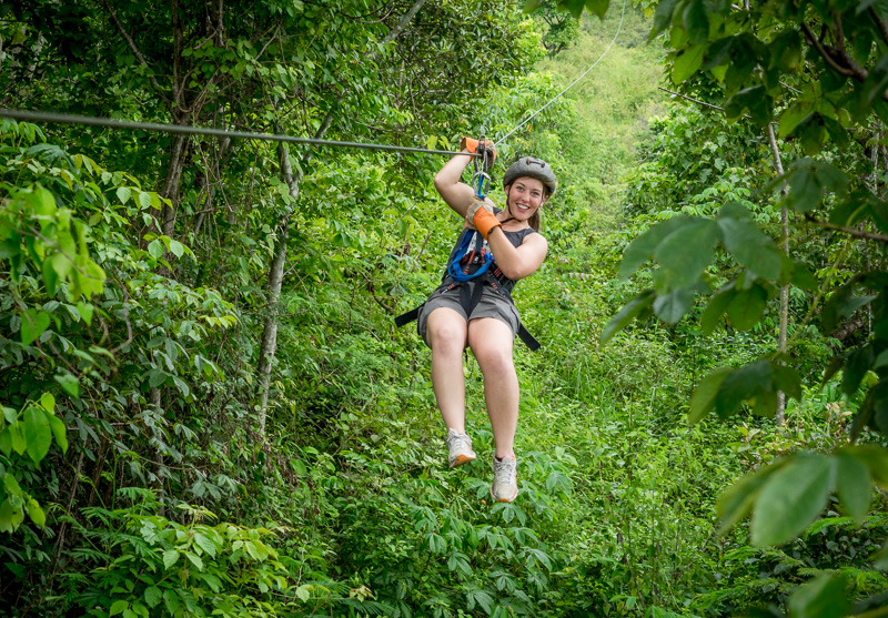 A woman smiles while ziplining in Copán, Honduras. GreatDistances / Matt Wicks