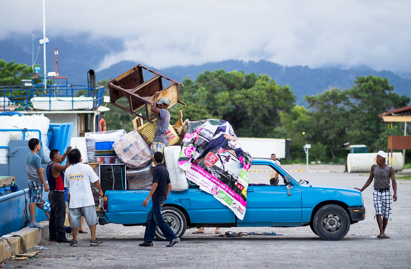 Men load a pickup truck to capacity and beyond in La Ceiba, Honduras. GreatDistances / Matt Wicks