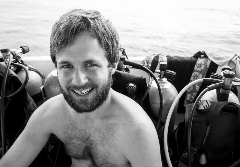 Man smiling on a diving boat in Utila, Honduras. GreatDistances / Matt Wicks