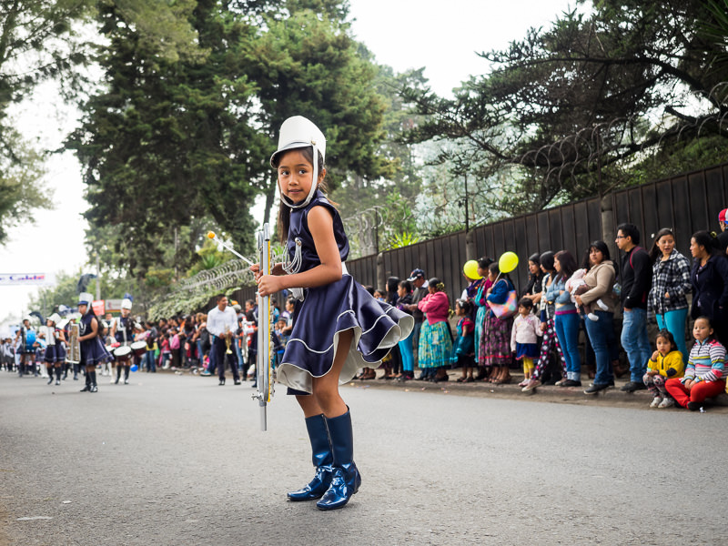 Girl with a musical instrument in a Guatemalan independence parade in Xela. Guatemalan Independence & Xela Feria 2014 - GreatDistances / Matt Wicks