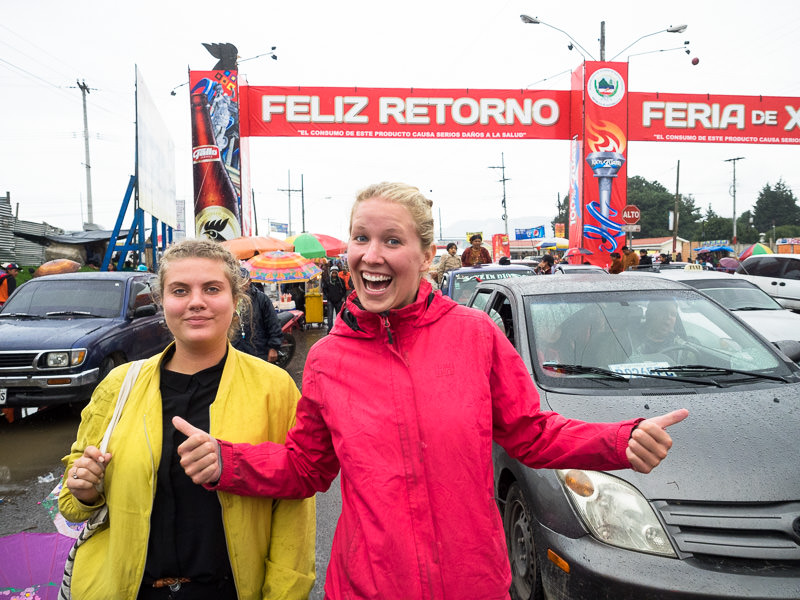 Two women walking in traffic to the Xela Feria - Quetzaltenango, Guatemala. Guatemalan Independence & Xela Feria 2014 - GreatDistances / Matt Wicks