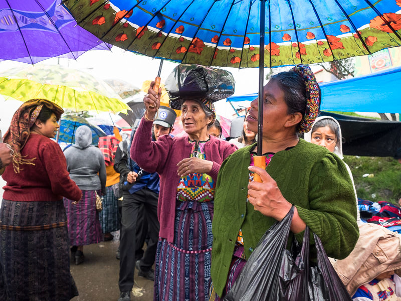 Guatemalan women with colorful parasols in Xela. Guatemalan Independence & Xela Feria 2014 - GreatDistances / Matt Wicks