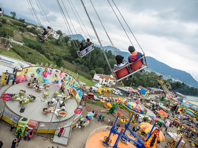 Riding the swings at Xela Feria in Quetzaltenango, Guatemala. Guatemalan Independence & Xela Feria 2014 - GreatDistances / Matt Wicks