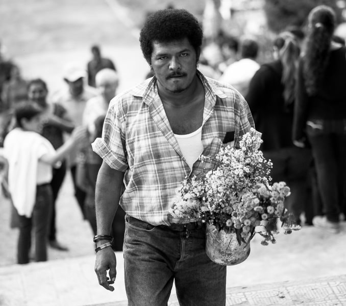 Man climbing stairs with flowers on Day of the Dead in Matagalpa, Nicaragua. GreatDistances / Matt Wicks