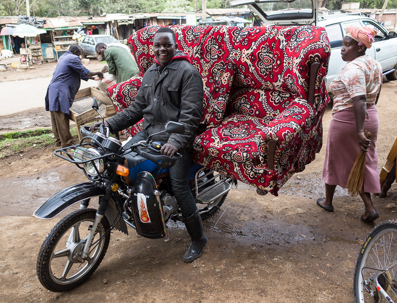 A man transports a full sofa on a motorbike in Nanyuki, Kenya. GreatDistances / Matt Wicks