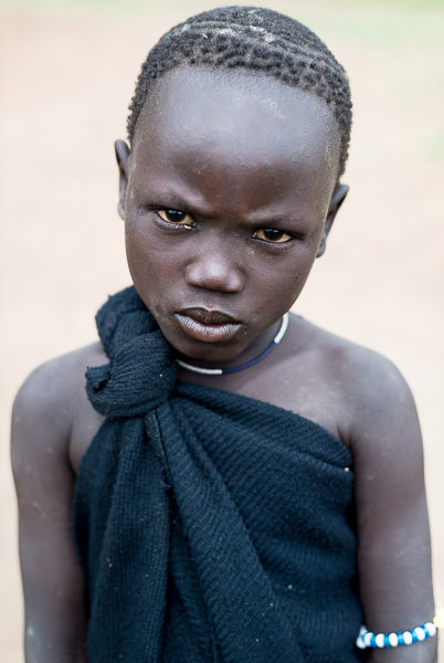 portrait, Mursi boy. Photographing the Tribes of South Omo, Ethiopia - GreatDistances / Matt Wicks