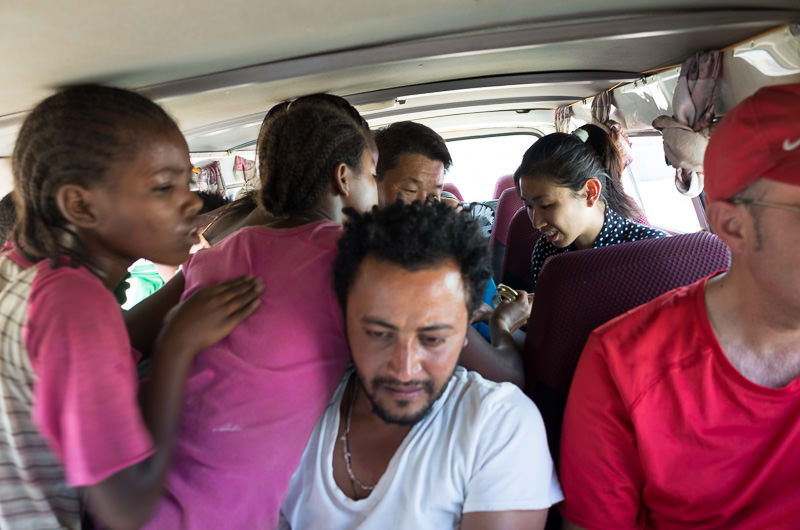 Local girls outside Karat-Konso mob crowd into a minibus to sell bracelets to tourists. How To Visit South Omo, Ethiopia (Omo Valley) - GreatDistances / Matt Wicks